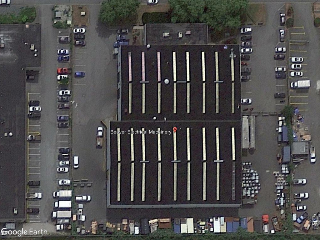 aerial view of a factory surrounded by vehicles