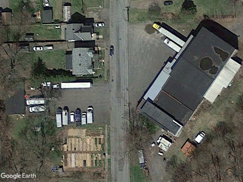 Aerial view of a building with trucks parked in front