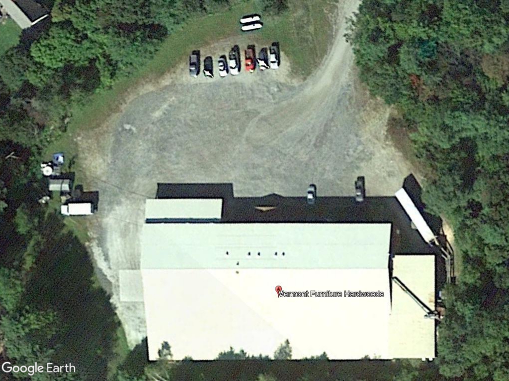 Aerial view of a building with a small parking
