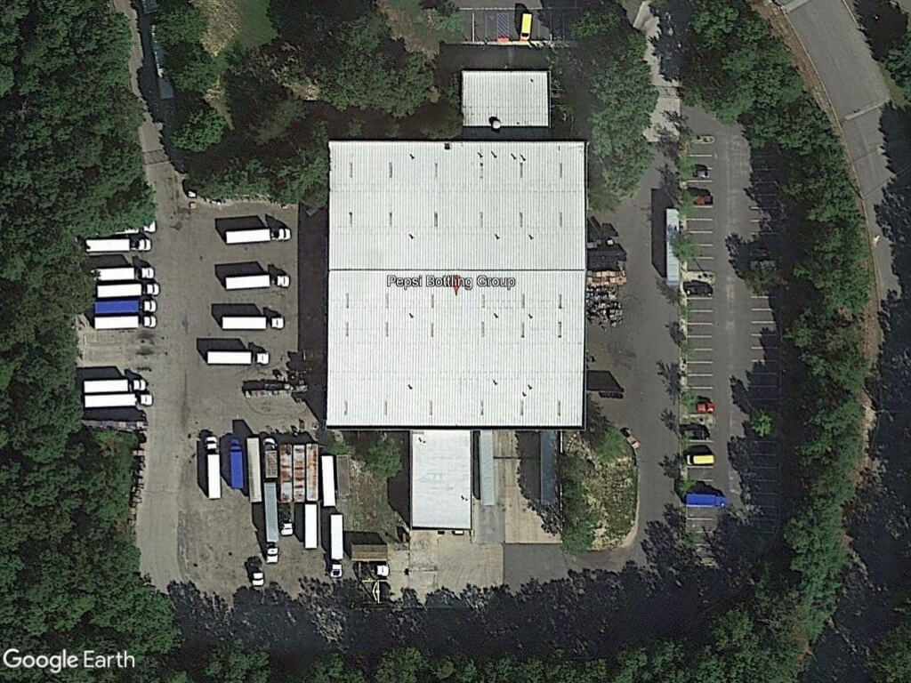 Aerial view of building surrounded by trucks